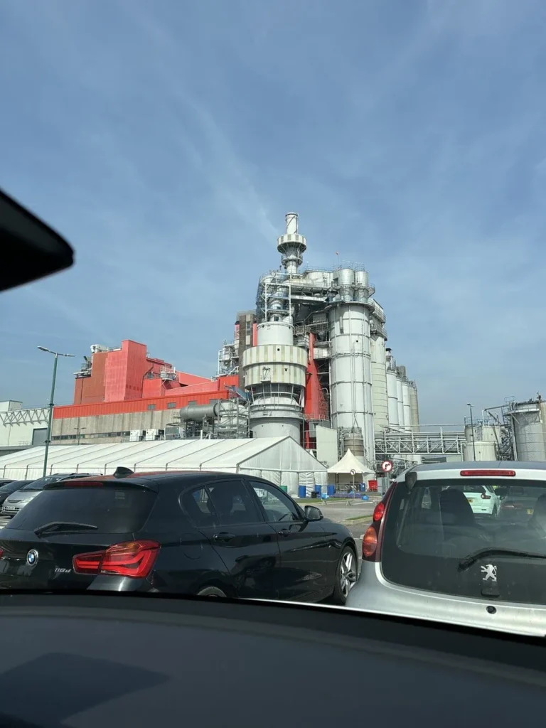 Cars in front of a manufacturing site.